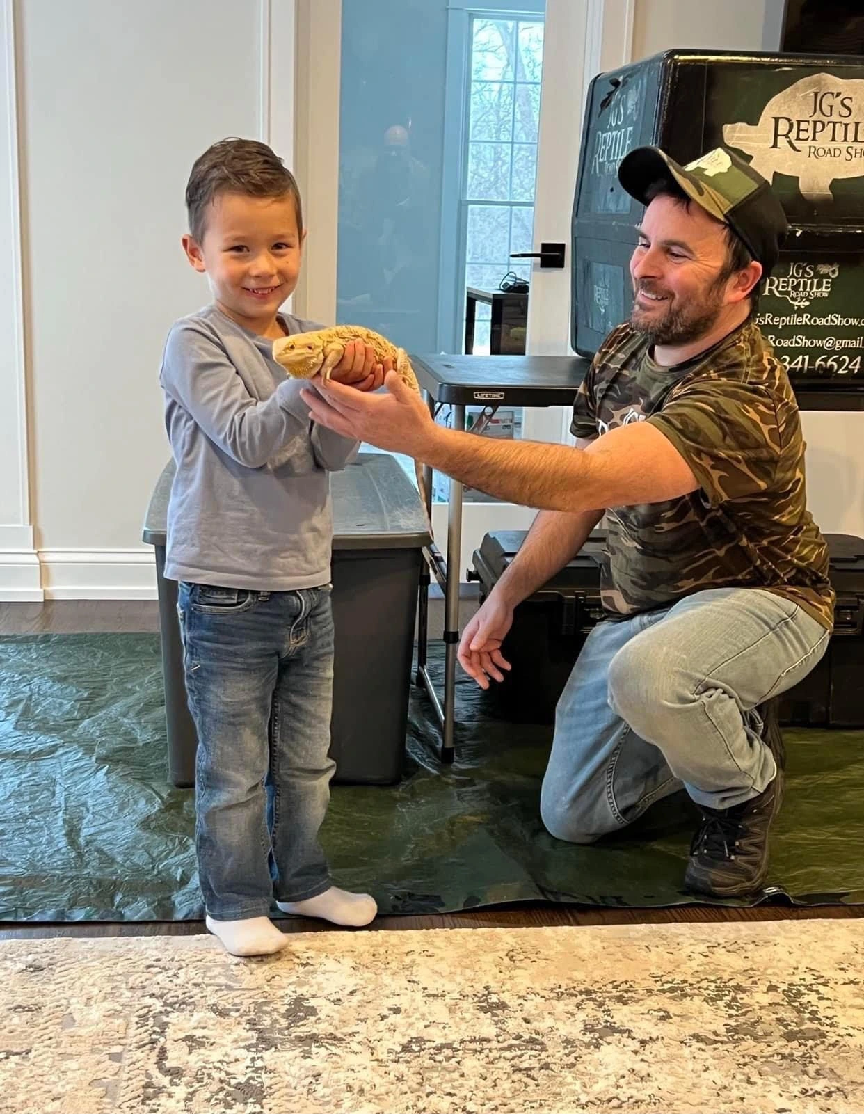 A child's delighted reaction to holding a friendly reptile