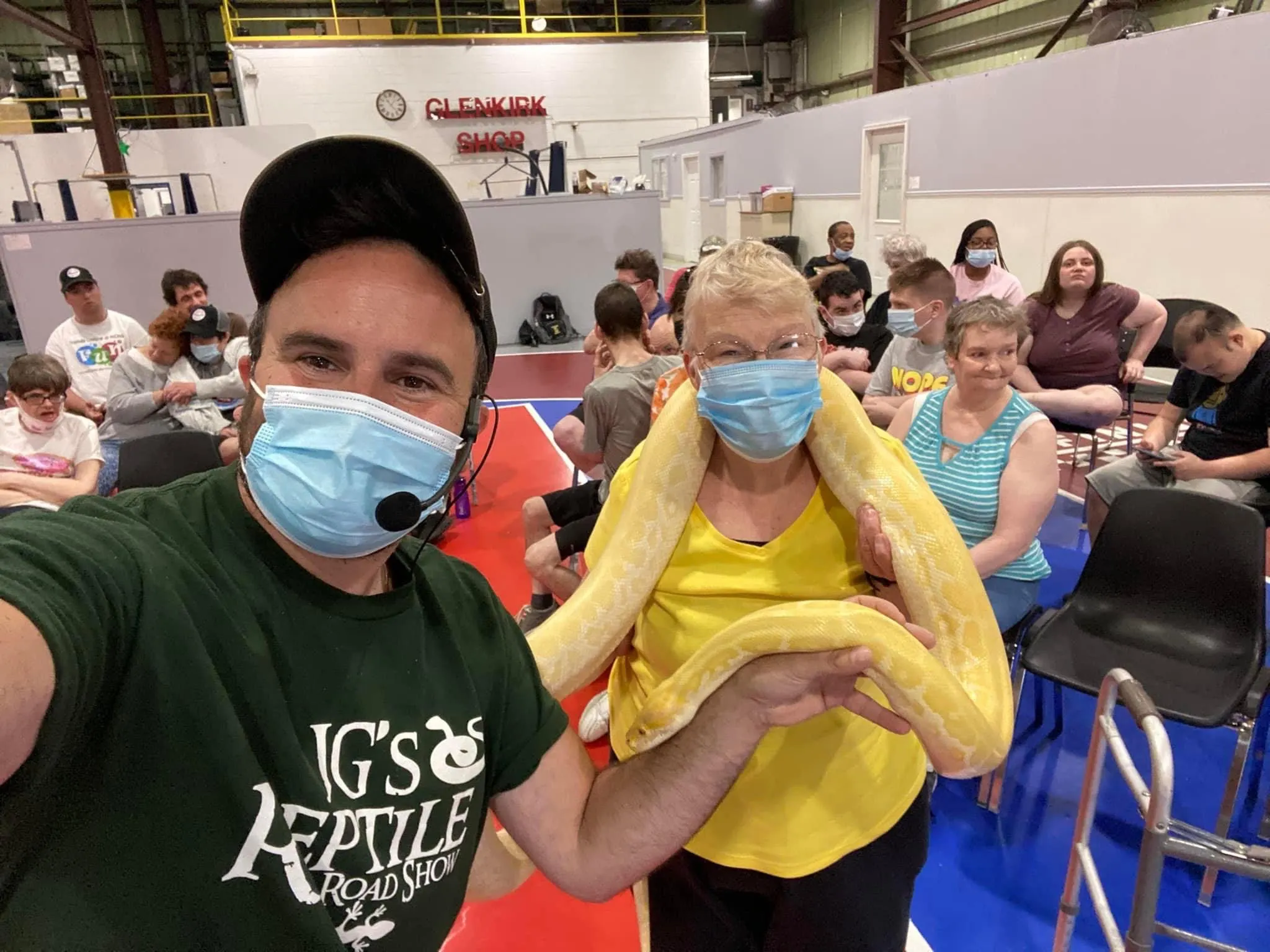 A child getting a photo with the Burmese python at a special event