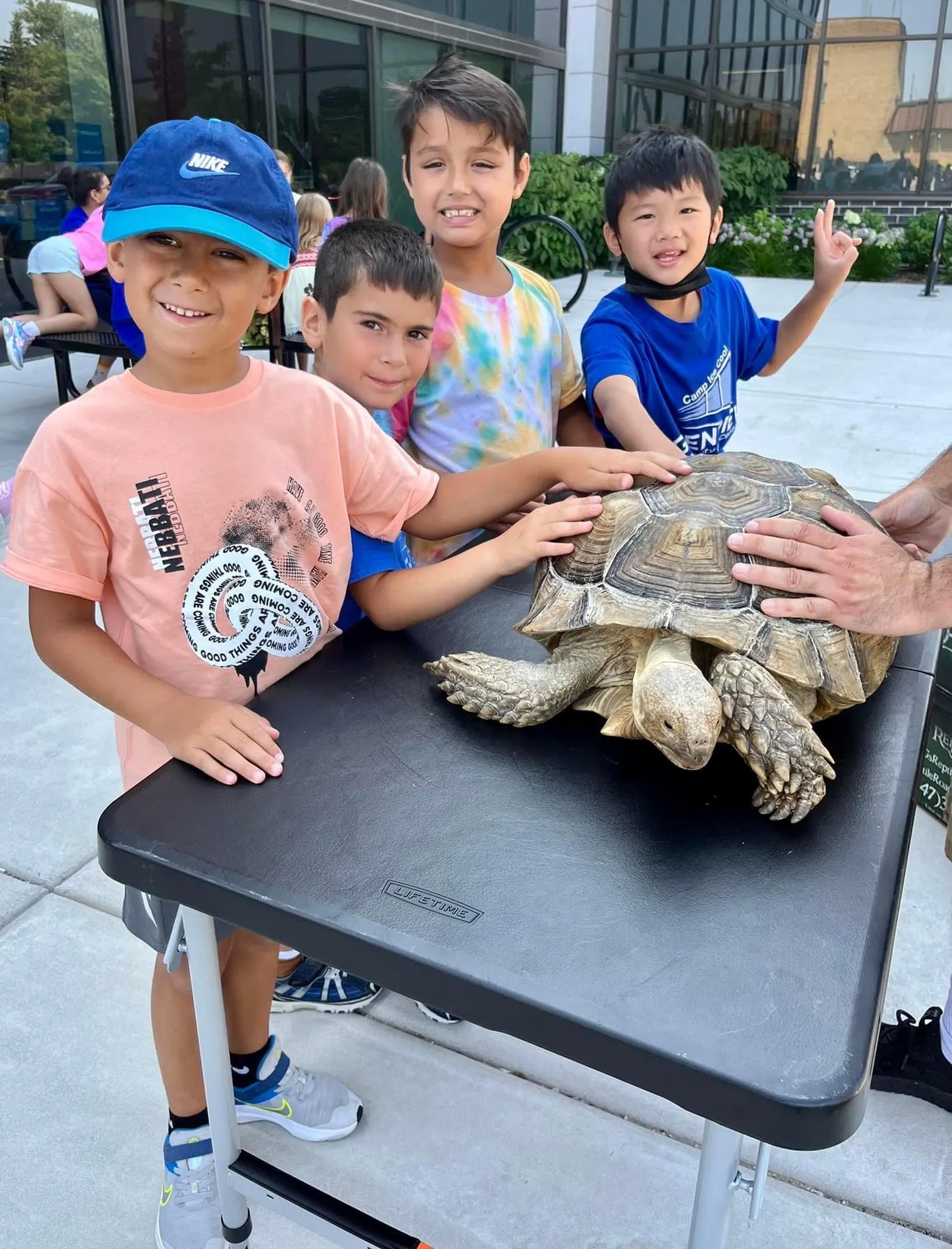 Children fascinated by a tarantula being presented up close